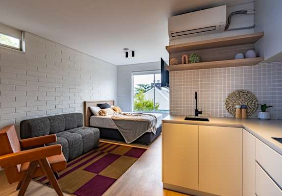 a small living room with a couch and a kitchen