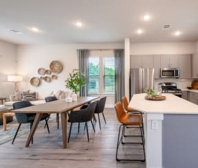 an open kitchen and dining area with a table and chairs