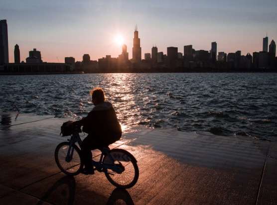 a person riding a bike near a body of water