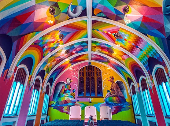 a church with a rainbow painted ceiling