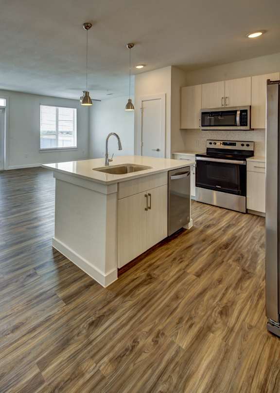 a kitchen with wooden cabinets and stainless steel appliances