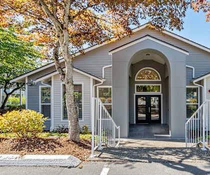 the front of a church building with stairs and a door