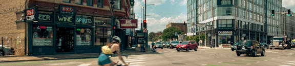 A cyclist is crossing the street in a city.