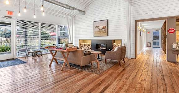a living room with a couch and a table and a fireplace