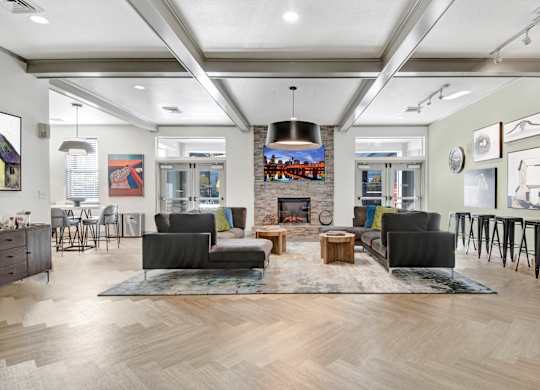 A modern living room with a fireplace and a large rug.