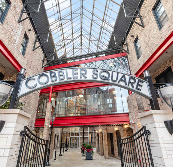 Cobblestone square entrance with a glass ceiling.