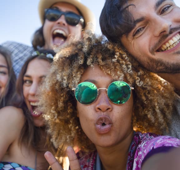 a group of people posing for a picture wearing sunglasses