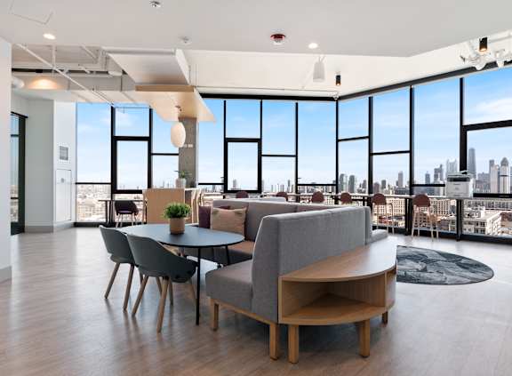 A modern living room with a view of the city skyline.