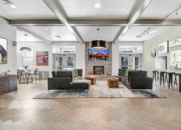 A modern living room with a fireplace and a large rug.