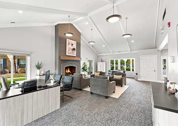 A modern living room with a fireplace and a large grey sofa.
