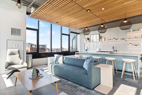 A modern living room with a blue couch and a wooden coffee table.
