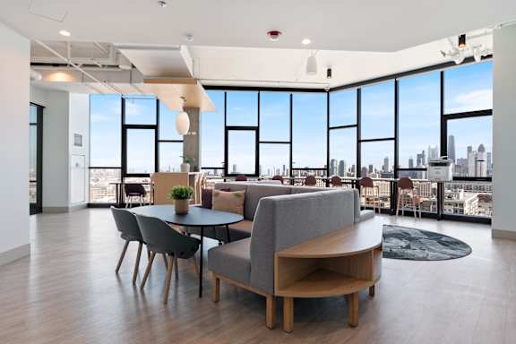 A modern living room with a view of the city skyline.