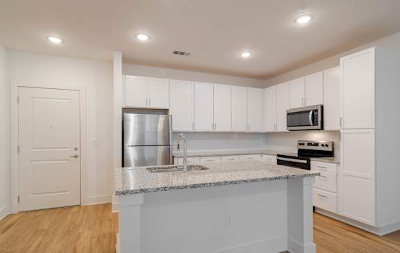 a living room with a couch and a coffee table at The Quincy Apartments in Acworth, GA 30102