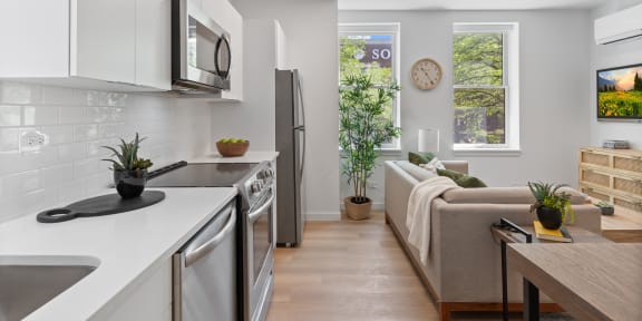 a kitchen and living room in a 555 waverly unit