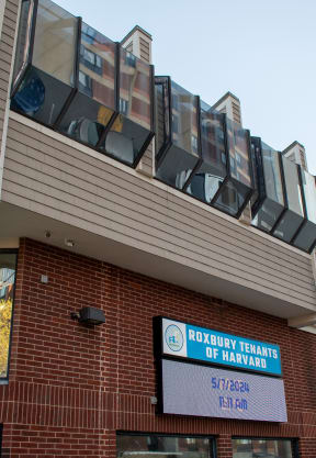 the front of a brick building with a sign for the county office of patient services