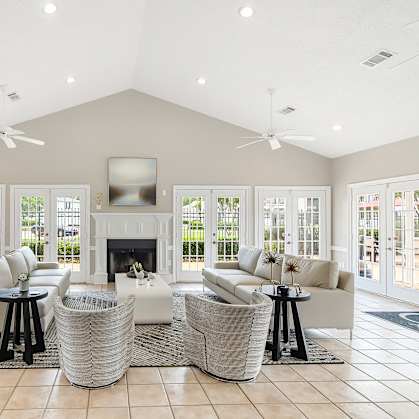 a living room with couches and chairs and a fireplace