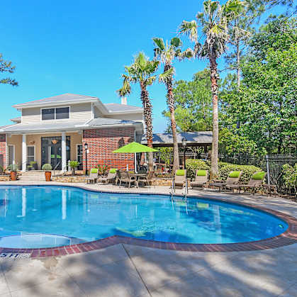 a swimming pool with a house in the background