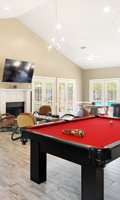 a game room with a pool table and a tv Lexington Pointe Apartment Homes in Oxford, Mississippi