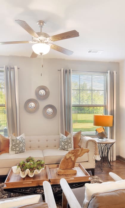 a living room with a ceiling fan and a couch at Audubon Park Apartment Homes, LA