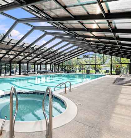 A large indoor pool with a glass ceiling.