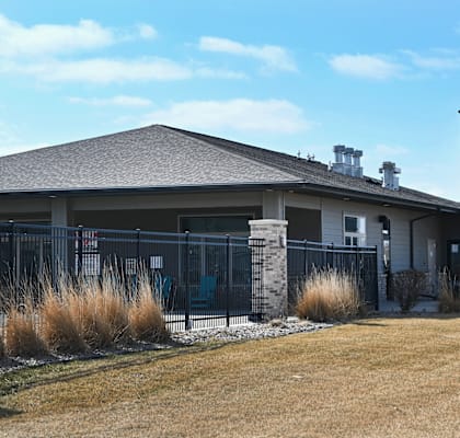 The Sterling apartments are located in a grassy area with a clear blue sky.
