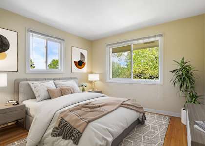 a bedroom with a bed and two windows