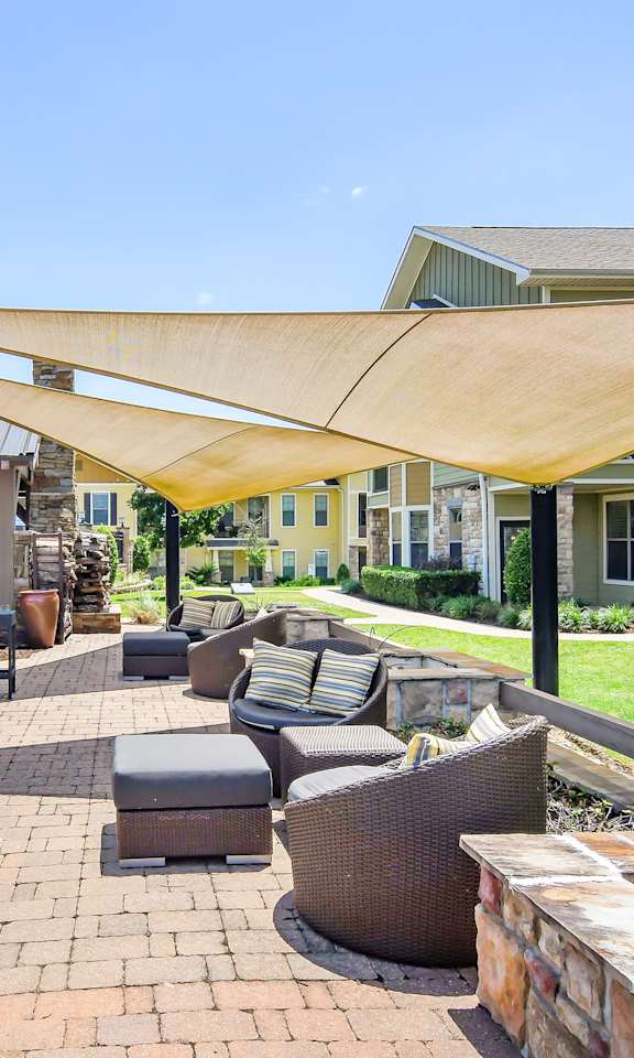 A patio with a table and chairs under a canopy.