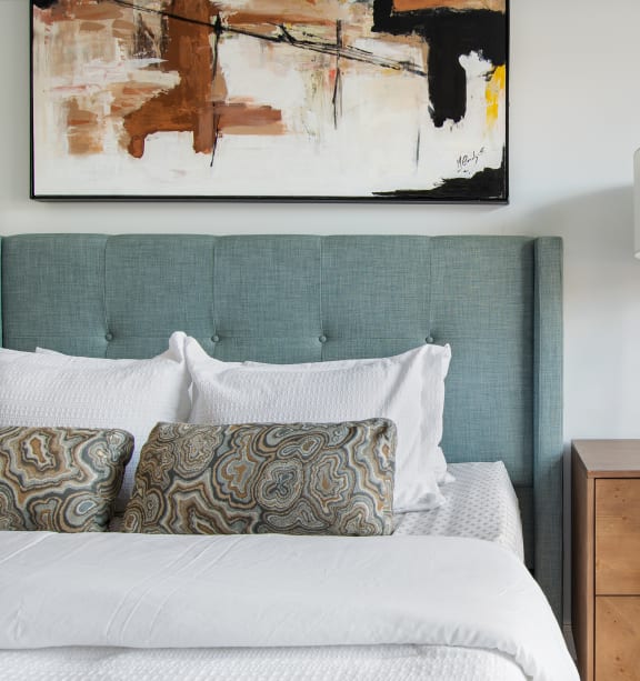 a bedroom with a bed and a nightstand with a lamp