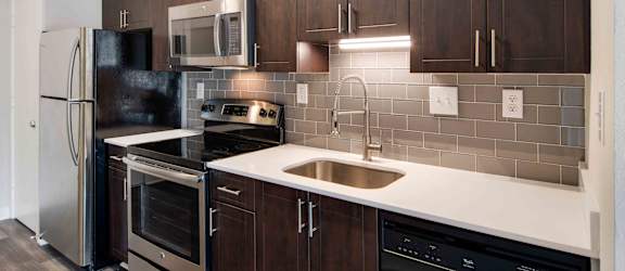 a kitchen with stainless steel appliances and wooden cabinets
