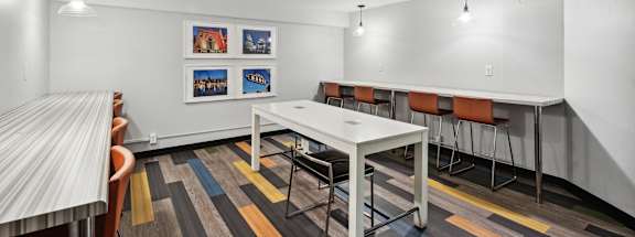 a conference room with a white table and chairs at Delmar Loop Apartments, St. Louis, MO, 63112