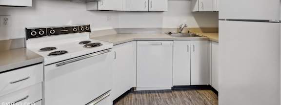 a white kitchen with white appliances and white cabinets at Delmar Loop Apartments, St. Louis, MO, 63112
