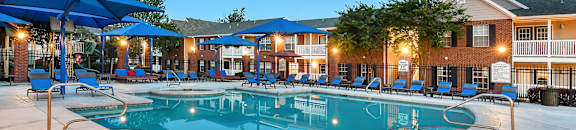 our resort style swimming pool is lit up at night at Bridgewater Apartment Homes, Brandon