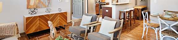a living room and dining room with a table and chairs at Audubon Park Apartment Homes, Zachary, Louisiana