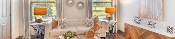 a living room with a ceiling fan and a couch at Audubon Park Apartment Homes, Zachary, LA