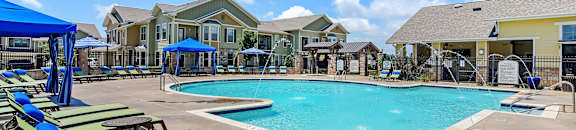 Relaxing Pool Area With Sundeck at Wellington Grande Apartment Homes, Longview