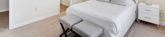 A bedroom with a bed, chair, and ceiling fan at Summit of Shreveport Apartments, Shreveport, 71105