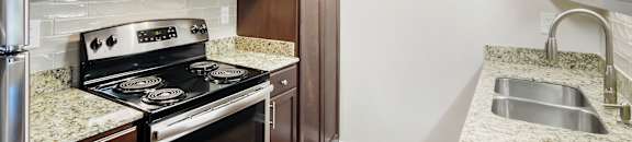 A kitchen with a stove, microwave, and refrigerator. at Lakeshore Pointe Apartment Homes, Brandon