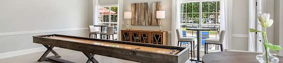 a living room with a pool table at Bridgewater Apartment Homes, Brandon, Mississippi