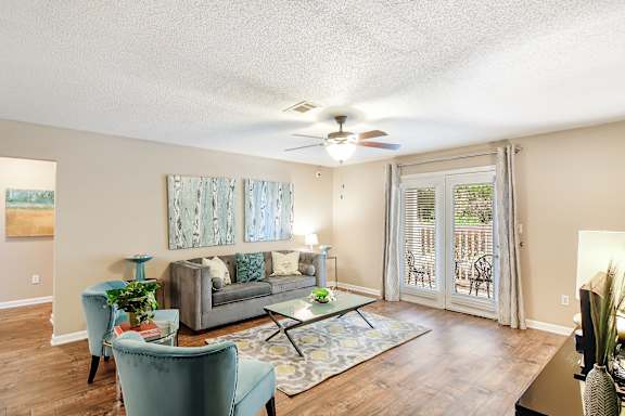 a living room with a couch and a ceiling fan