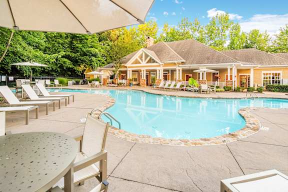 a large green apartment building with trees in front of it  at Quail Ridge Highlands Apartment Homes, Bartlett, 38135