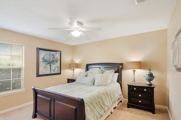 a rendering of a living room with a kitchen in the background at The Colony Apartment Homes, Mississippi, 39702