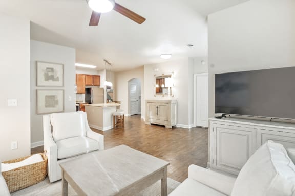 a living room with a white couch and a green coffee table  at Faulkner Flats Apartment Homes, Oxford