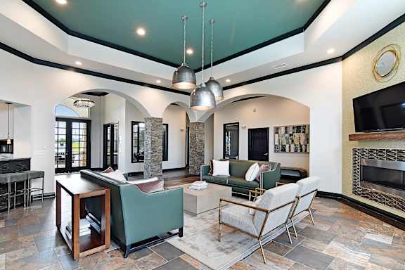 a kitchen and dining room with a table and chairs  at Wellington Grande Apartment Homes, Longview, TX