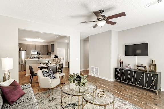 a bedroom with a bed and a ceiling fan  at Lagniappe of Biloxi Apartment Homes, Biloxi, MS