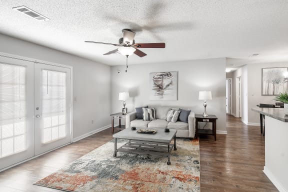 a rendering of a living room with a kitchen in the backgroundat The Pointe Apartment Homes, Gautier, 39553