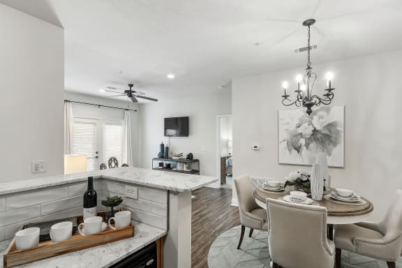 a living room with a ceiling fan and a couch at Charleston Apartment Homes, Alabama