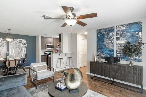 a living room with a kitchen in the background at Parkwest Apartment Homes in Hattiesburg, Mississippi
