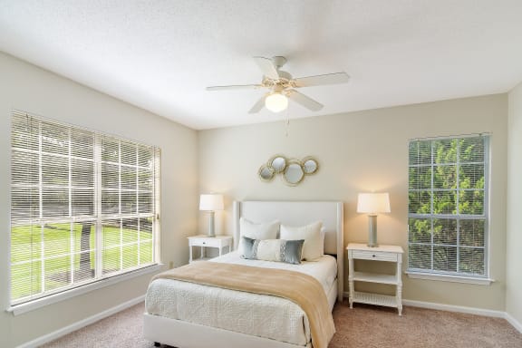 a bedroom with a bed and a ceiling fan at Legacy Apartment Homes, Ridgeland, MS