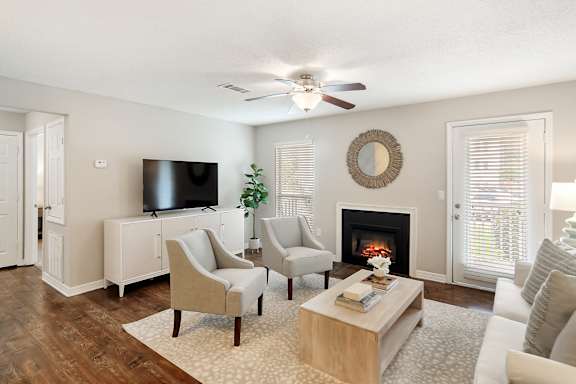 a living room with a fireplace and a ceiling fan at Lakeshore Pointe Apartment Homes, Mississippi, 39047
