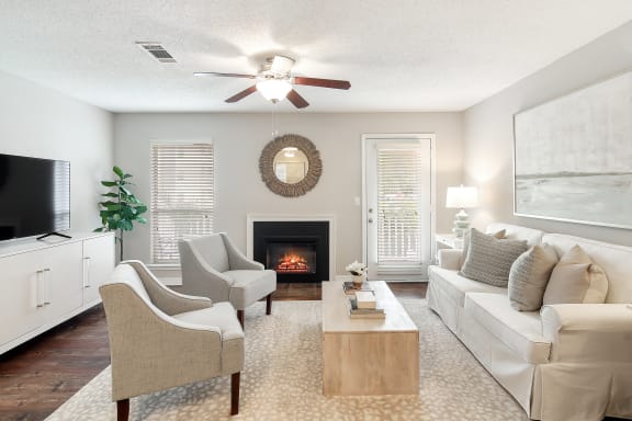 a swimming pool with chaise lounge chairs and a pool house in the background at Lakeshore Pointe Apartment Homes, Brandon, MS